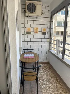 a small table and two chairs on a balcony at Arena 011 in Novi Beograd