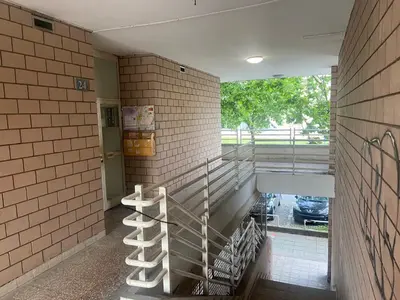 a hallway with a staircase in a brick building at Arena 011 in Novi Beograd