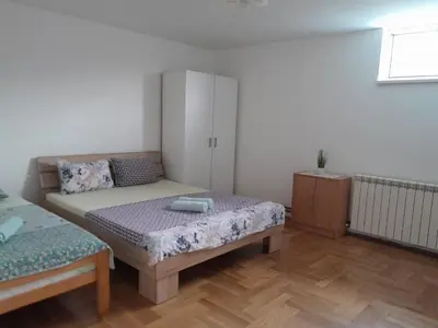 a small bedroom with a bed and a cabinet at Apartment Ken 1 in Surčin
