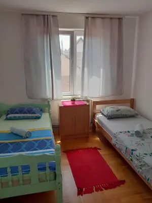 a bedroom with two beds and a window at Apartment Ken 1 in Surčin