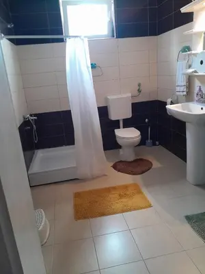 a bathroom with a toilet and a tub and a sink at Apartment Ken 1 in Surčin