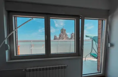 a window in a room with a view of a building at Owl Apartment in Belgrade