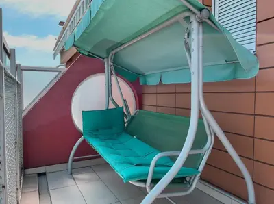 a swing on the balcony of a building at Owl Apartment in Belgrade