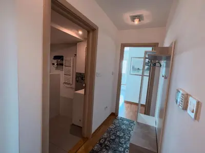 a bathroom with a walk in shower and a glass door at Owl Apartment in Belgrade