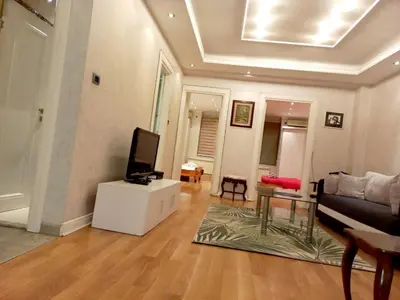 a living room with a couch and a tv at Alex LUX in Belgrade