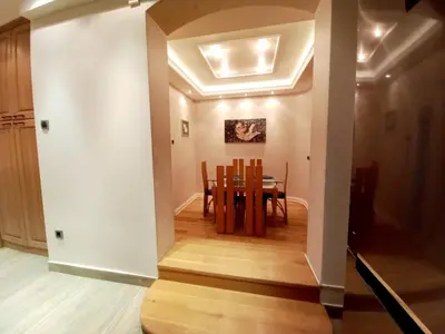 a dining room and kitchen with a table and chairs at Alex LUX in Belgrade