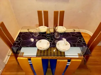 a dining table with glasses and plates on it at Alex LUX in Belgrade