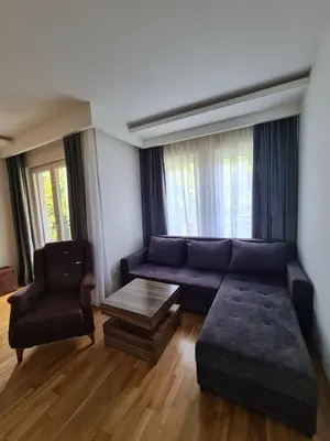 a living room with a couch and a chair at Friend LUX Apartman Beograd in Belgrade