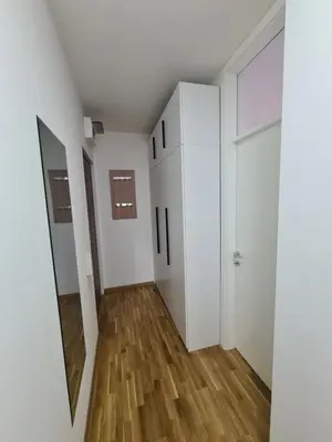 a room with white walls and wooden floors at Friend LUX Apartman Beograd in Belgrade