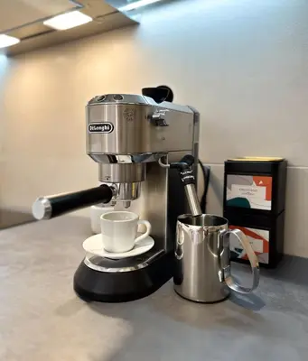 a coffee machine sitting on a counter with a cup at Belgrade Riverfront Fortress Apartment in Belgrade