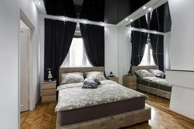 a bedroom with two beds and two windows at Hedonist-Belgrade Central Nest in Belgrade