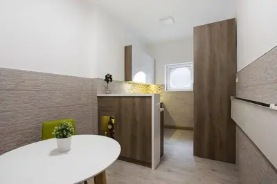 a dining room with a white table in a room at Hedonist-Belgrade Central Nest in Belgrade