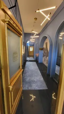 a hallway with blue walls and a hallway with stars on the floor at Royal Wellness and Spa in Ruma