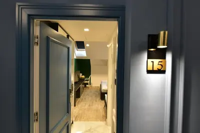 a door leading to a hallway with a number sign at Royal Wellness and Spa in Ruma