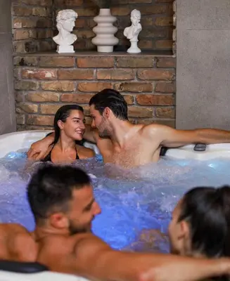 a group of people in a hot tub at Royal Wellness and Spa in Ruma