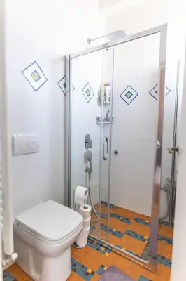 a bathroom with a toilet and a glass shower at Ugi house - City Center in Belgrade