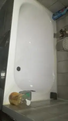 a white sink in a bathroom with a knife at Quiet place near the city center in Sajmište