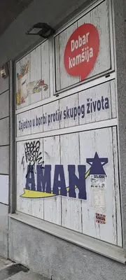 a sign on the side of a building with a sign for a mall at Quiet place near the city center in Sajmište
