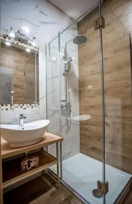 a bathroom with a sink and a glass shower at Apartman Provance in Batajnica