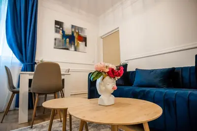 a living room with a vase with flowers on a table at Apartman Provance in Batajnica