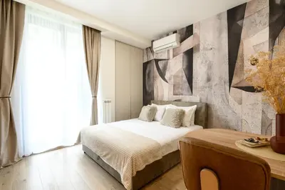 a bedroom with a bed and a large window at inJoy in Belgrade