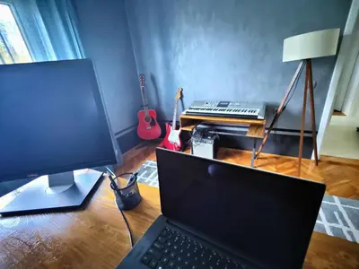 a desk with a laptop computer and a keyboard at Hedonists Paradise in Omoljica