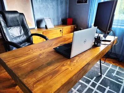 a laptop computer sitting on top of a wooden desk at Hedonists Paradise in Omoljica