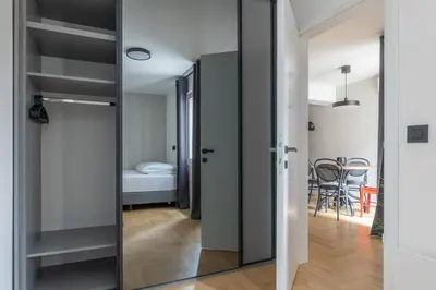 a glass door leading into a room with a bedroom at HostGost Selected Suites – Parliament in Belgrade