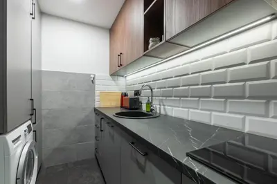 a kitchen with a sink and a counter top at HostGost Selected Suites – Parliament in Belgrade