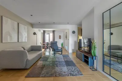 a living room with a couch and a tv at HostGost Selected Suites – Parliament in Belgrade