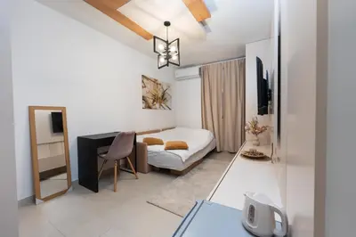 a living room with a bed and a desk at Comanda LUXURY APARTMENTS in Belgrade
