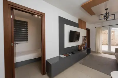 a living room with a tv on a wall at Comanda LUXURY APARTMENTS in Belgrade