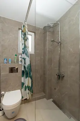 a bathroom with a shower and a toilet at Comanda LUXURY APARTMENTS in Belgrade