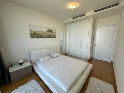 a bedroom with a white bed in a room at Queen BW in Sajmište
