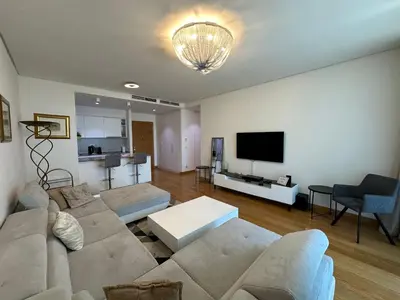 a living room with a couch and a tv at Queen BW in Sajmište
