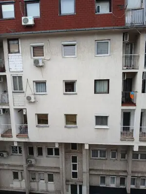 an apartment building with windows and balconies at Martin in Belgrade