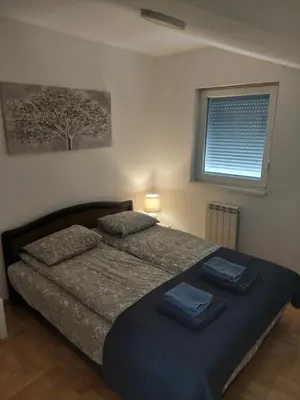 a bedroom with a bed with two towels on it at Flat 23 in Belgrade