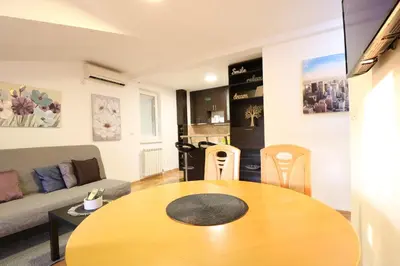 a living room with a table and a couch at Flat 23 in Belgrade