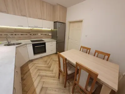 a kitchen with a table and chairs and a sink at Apartment Pegy in Novi Grad
