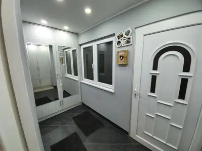 a bathroom with a white door and a mirror at Apartment Pegy in Novi Grad