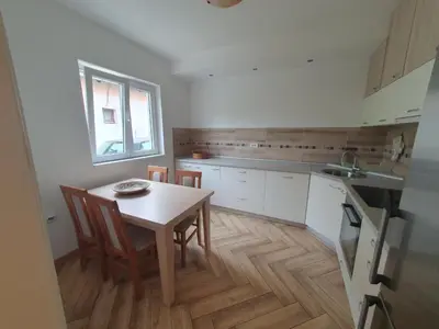 a kitchen with a table and chairs and a window at Apartment Pegy in Novi Grad