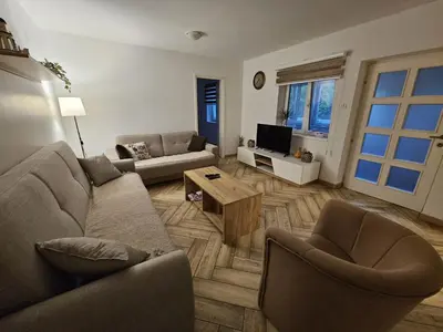 a living room with two couches and a tv at Apartment Pegy in Novi Grad