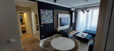 a living room with a white table and chairs and a living room at BW VERDE LUX in Sajmište