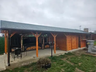 a pavilion with a table and chairs in a yard at Vila Tea Fruska Gora in Čortanovci