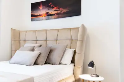 a bedroom with a bed with pillows on it at BW VERDE DREAM in Sajmište