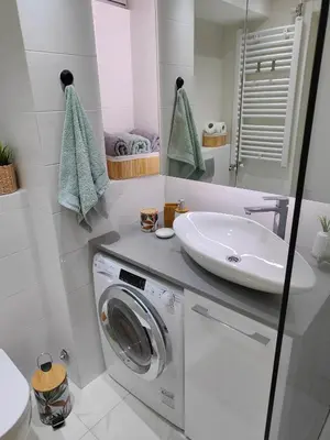 a bathroom with a washing machine and a sink at Relax in Belgrade