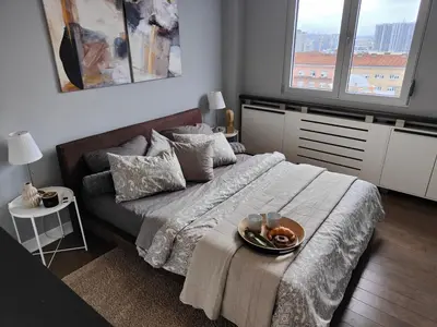a bedroom with a bed with a tray of food on it at Relax in Belgrade