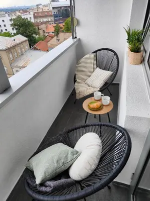 a balcony with a chair and a table on a balcony at Relax in Belgrade