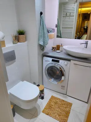 a bathroom with a washing machine and a sink at Relax in Belgrade