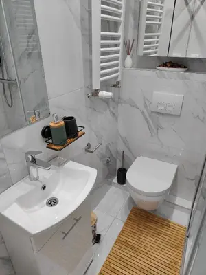 a white bathroom with a sink and a toilet at Elixir in Belgrade